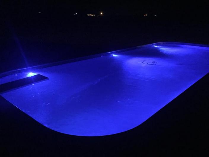 A beautiful pool at night with this great lighting.